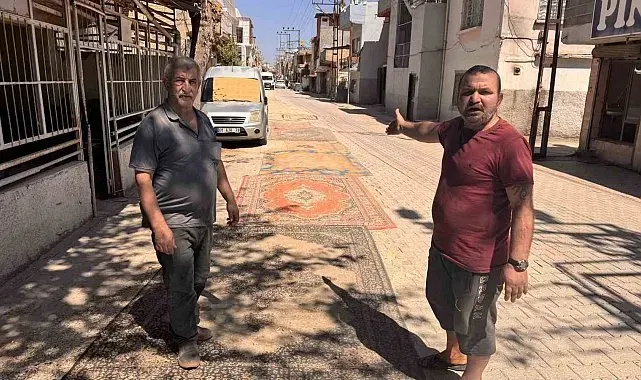 Tozdan bunalan mahalleli çareyi sokağa halı sermekte buldu